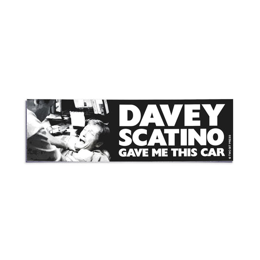 A vinyl bumper sticker showing the Sopranos and the text "DAVEY SCATINO GAVE ME THIS CAR" on a white background.