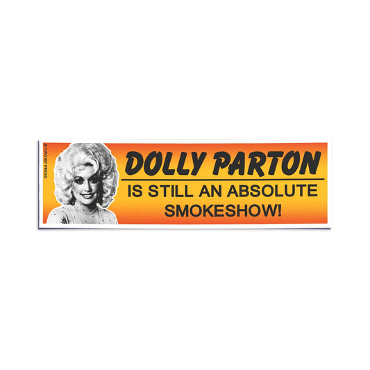 A vinyl bumper sticker showing Dolly Parton and the text "DOLLY PARTON IS STILL AN ABSOLUTE SMOKESHOW" on a white background.