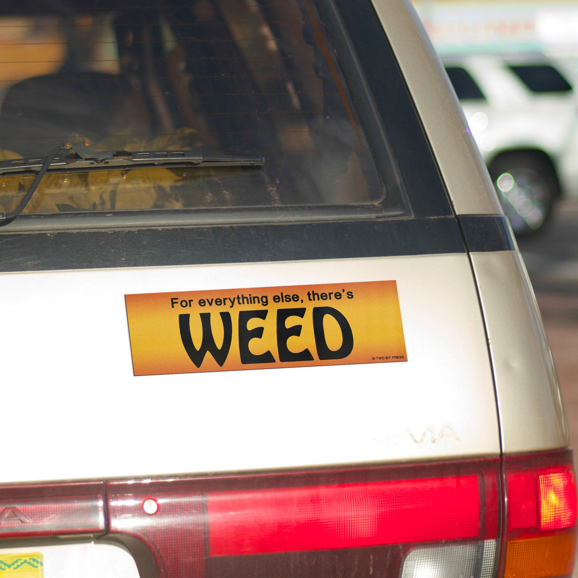 A vinyl bumper magnet reading "For everything else, there's WEED" on gold minivan.
