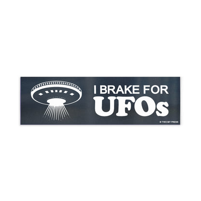 A vinyl bumper magnet showing a flying saucer and the text "I BRAKE FOR UFOS" on a white background.
