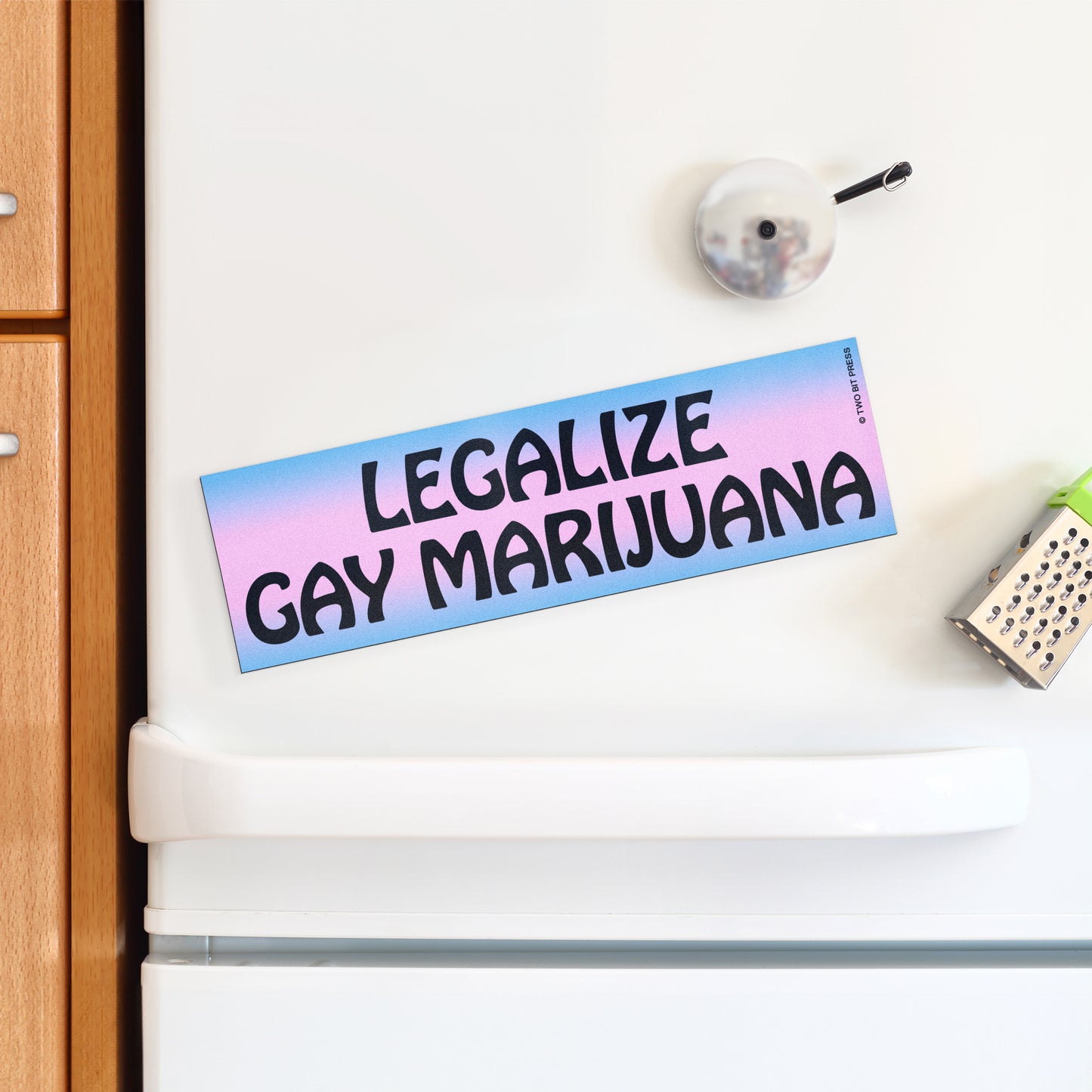 A vinyl bumper magnet reading "LEGALIZE GAY MARIJUANA" on a white fridge.