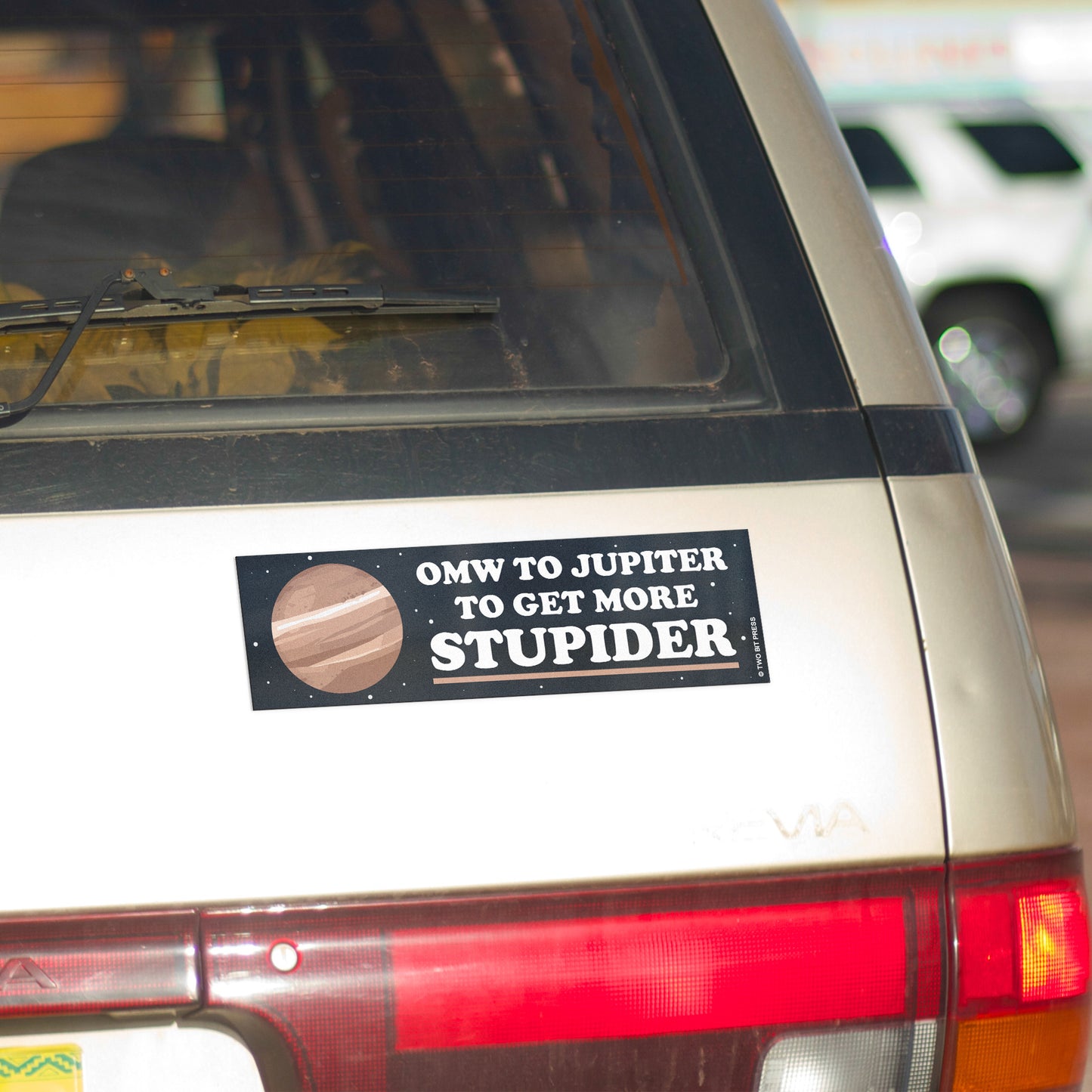 A vinyl bumper magnet showing Jupiter and the text "OMW to JUPITER" on gold minivan.