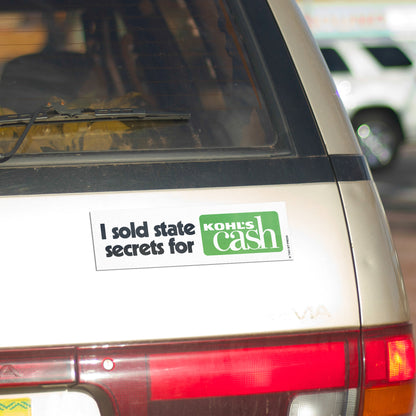 A vinyl bumper magnet reading "I sold state secrets for KOHL'S cash" on gold minivan.