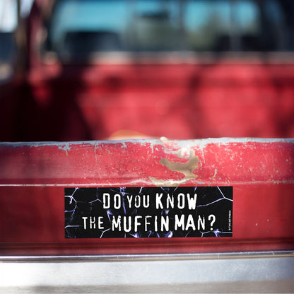 A vinyl bumper magnet reading "DO YOU KNOW THE MUFFIN MAN?" on red truck tailgate.