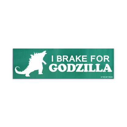 A vinyl bumper magnet showing Godzilla and the text "I BRAKE FOR GODZILLA" on a white background.