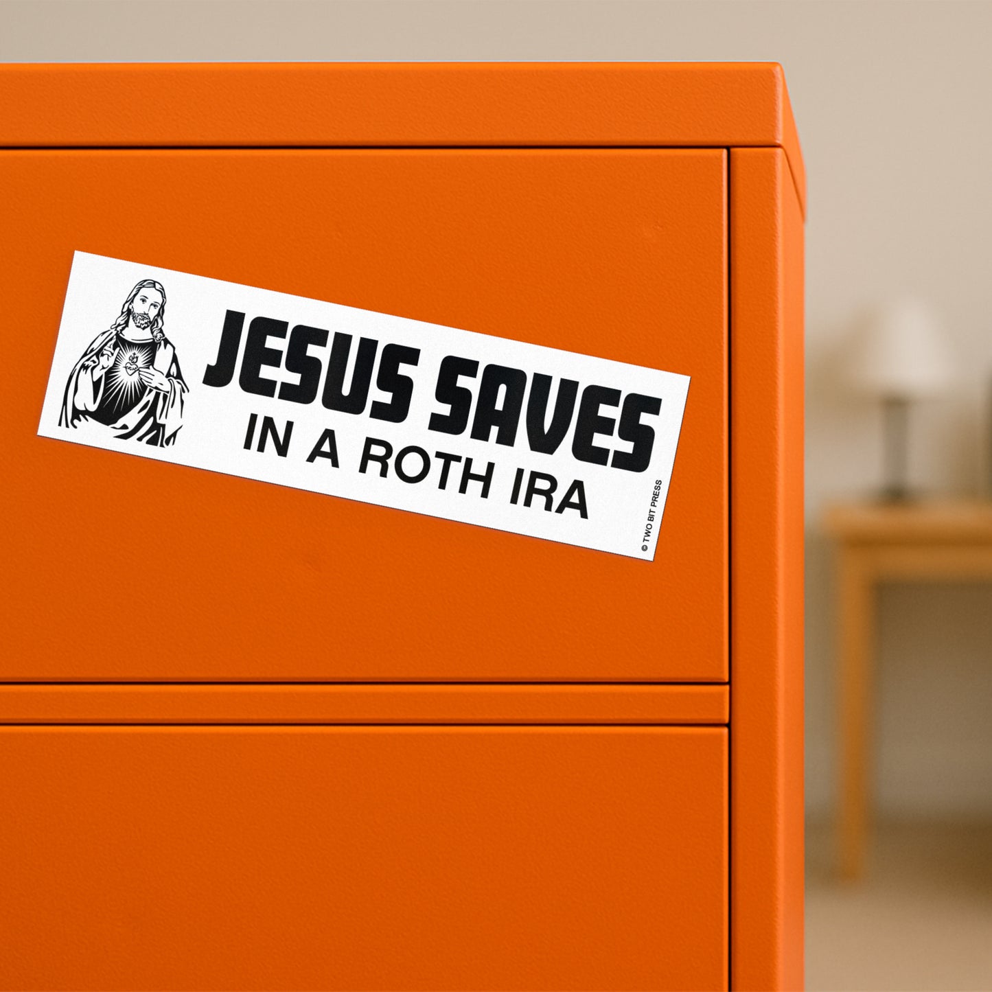 A vinyl bumper magnet showing Jesus and the text "JESUS SAVES IN A ROTH IRA" on orange filing cabinet.