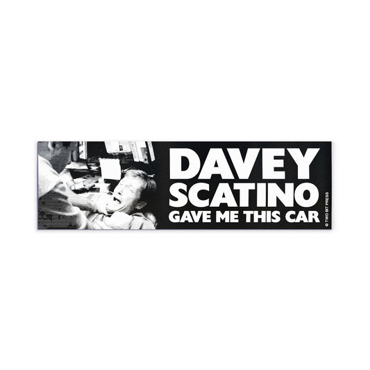 A vinyl bumper magnet showing the Sopranos and the text "DAVEY SCATINO GAVE ME THIS CAR" on a white background.