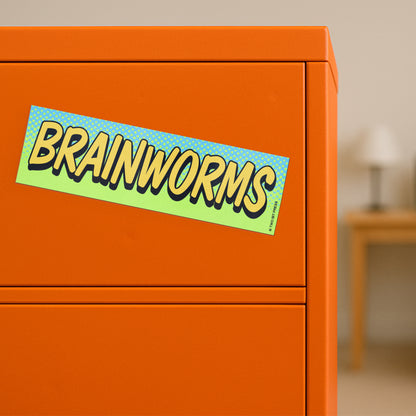 A vinyl bumper magnet reading "BRAINWORMS" on orange filing cabinet.
