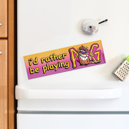 A vinyl bumper magnet reading "i'd rather be playing POG" on a white fridge.
