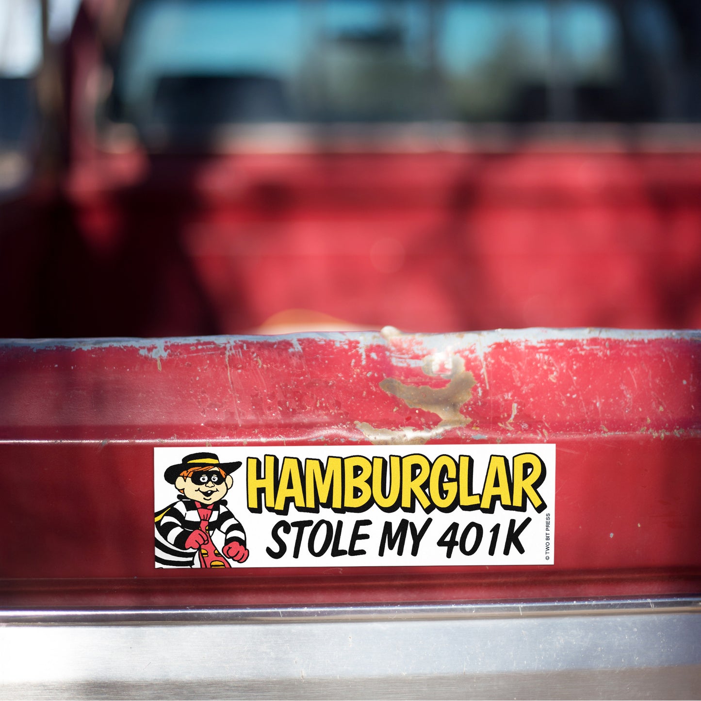 A vinyl bumper magnet showing the Hamburglar and the text "HAMBURGLAR STOLE MY 401K" on red truck tailgate.