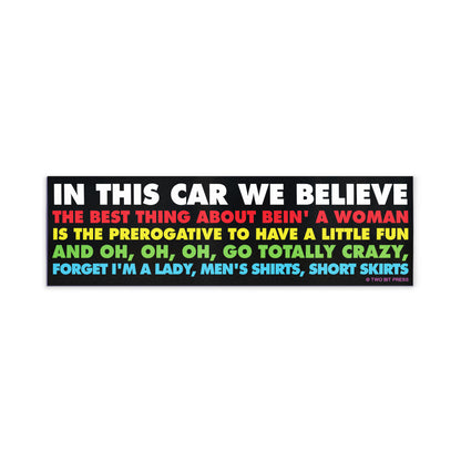 A vinyl bumper magnet reading "IN THIS CAR WE BELIEVE THE BEST THING ABOUT BEING A WOMAN" on a white background.