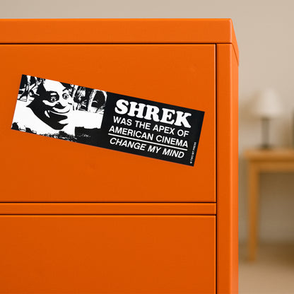A bumper magnet showing Shrek and the text "SHREK WAS THE APEX OF AMERICAN CINEMA. CHANGE MY MIND" on orange filing cabinet.