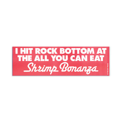 A vinyl bumper magnet reading "I HIT ROCK BOTTOM AT THE ALL YOU CAN EAT Shrimp Bonanza" on a white background.