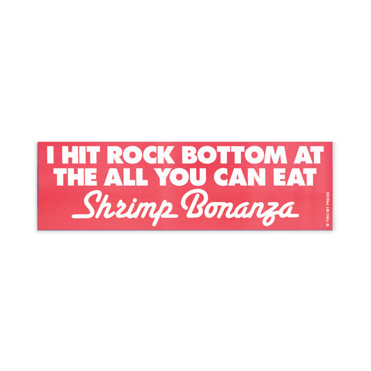 A vinyl bumper magnet reading "I HIT ROCK BOTTOM AT THE ALL YOU CAN EAT Shrimp Bonanza" on a white background.